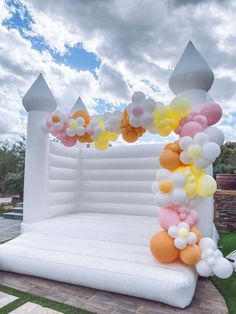 an inflatable arch is decorated with balloons