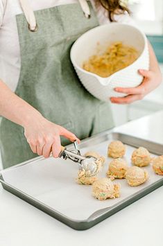 a woman in an apron is making food