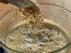 someone is mixing ingredients in a glass bowl