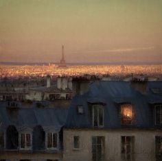 an image of a cityscape at dusk with the eiffel tower in the distance