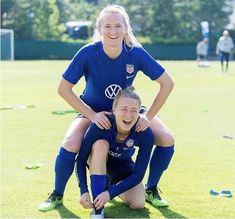 two female soccer players posing for a photo