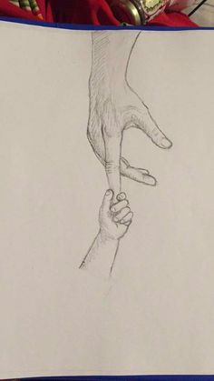 a pencil drawing of two hands holding each other's hand on top of a piece of paper