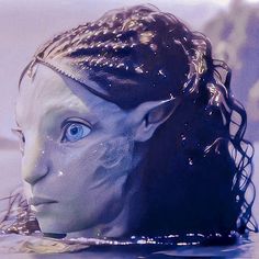 a close up of a person's head with water on it and hair in the air