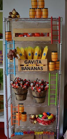 a metal rack filled with lots of cupcakes next to a shelf full of bananas