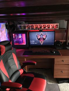 a computer desk with two monitors and a gaming chair in front of the monitor screen