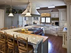 a large kitchen with an island and chairs