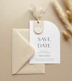 a save the date card and envelope on top of a table