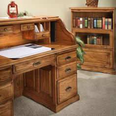 a wooden desk with two bookshelves and a book case in the corner next to it