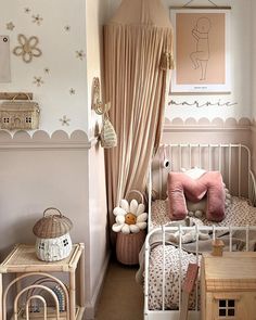 a small child's bedroom with pink and white decor