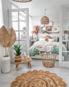 a bedroom with wicker furniture and plants in the corner