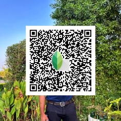 a man is holding up a qr code