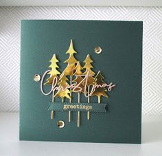 a christmas card with gold trees on it