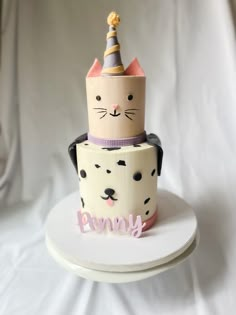 a birthday cake with a cat on top