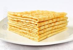 a stack of pancakes sitting on top of a white plate