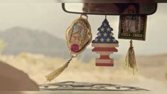 an american flag decoration hanging from the side of a car