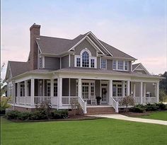 a large house sitting on top of a lush green field