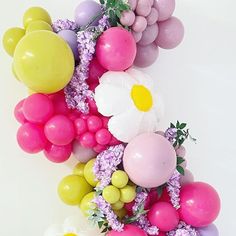 a bunch of balloons and flowers on a table