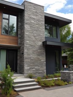 a modern house with stairs leading to the front door