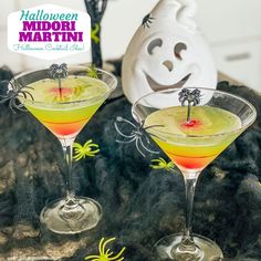 two halloween martinis are sitting on a table