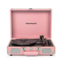 a pink suitcase with a record player in it and the word crosley on top