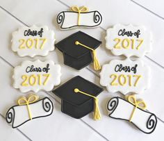 decorated cookies with graduation caps and diplomas for the class of 2017 on a table