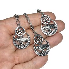 "You will receive one of the pentacle raven/crow pendants shown in the photos. These are available as just the pendant or with your choice of chain. Each pendant is made with a lead-free and nickel-free zinc alloy. Each necklace comes in its own gift box! (if multiple pendants are ordered without a chain, they may be packed together in one gift box) Chain options are: Silver Plated Stainless Steel 2.2mm cable  Silver Stainless Steel 2mm cable: Hypoallergenic and tarnish resistant! Sterling Silver 2mm Cable: Hypoallergenic Chain extenders for adjustability can be added upon request at an additional cost. The matching earrings can be found here: ~~IMPORTANT~~ Be sure to double-check the shipping address before placing an order. Once orders have been shipped out, I cannot do anything to chang Gothic Stainless Steel Nickel-free Necklaces, Raven Wing Necklace, Crow Necklace, Pentacle Necklace, Crow Pendant, Raven Necklace Pendants, Pentagram Necklace, Spiritual Necklace, Pentagram Pendant