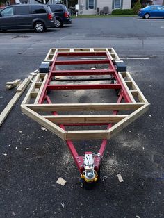 there is a trailer that has been made out of wood and plywood on the ground