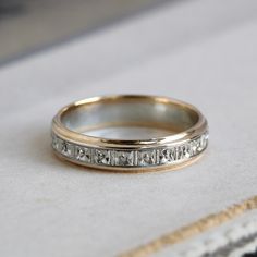 a wedding band with roman numerals is shown on top of a white cloth