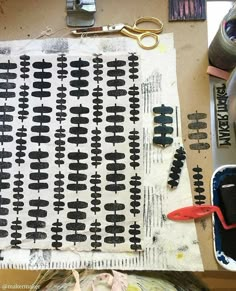 the fabric is being made with scissors and other crafting supplies on top of a table