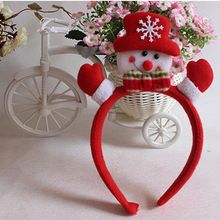 there is a stuffed snowman sitting on a bicycle with flowers in the basket behind it