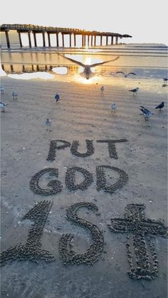 the words put god in the sand with seagulls