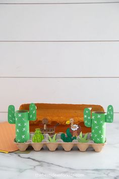 a hot dog in a bun with cactus decorations on it, sitting on a counter