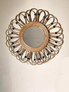 a circular mirror hanging on the wall