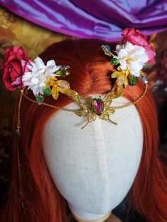 Introducing my enchanting Floral Fantasy Tiara - where elegance meets nature's charm! This delicate tiara features gold tones with shimmering accents and stunning red and cream artificial flowers on each side. In the center, a breathtaking crystal butterfly takes flight, surrounded by cascading beads and glimmering details. The floral elements create a whimsical fairy-tale aura, perfect for fantasy lovers, cosplay, weddings, or any event where you want to feel magical. This one-of-a-kind piece i Whimsical Handmade Cosplay Headpieces, Red Fantasy Costume Headpieces, Fantasy Tiara, Delicate Tiara, Gold Fairy Headpiece, Fairy Jewelry Tiara, Elf Headpiece, Woodland Fairy Crown, Fairy Tiara