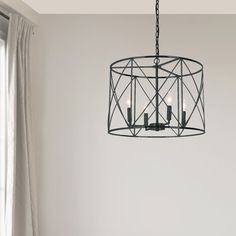 a chandelier hanging from the ceiling in a room with white walls and curtains