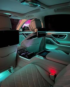 the interior of a car with its lights on and electronic gadgets lit up at night