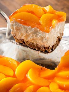 there is a piece of cake on a spoon with oranges around it and the rest of the pie in the background