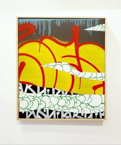 a painting hanging on the wall next to a white wall with red and yellow graffiti