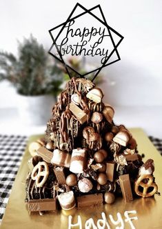 a birthday cake with chocolate and marshmallows in the shape of a pyramid