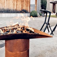 a fire pit sitting on top of a sidewalk