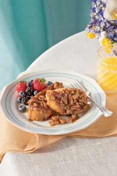 a white plate topped with french toast and fruit