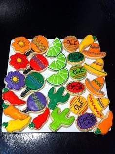 decorated cookies are arranged in the shape of fruits and vegetables