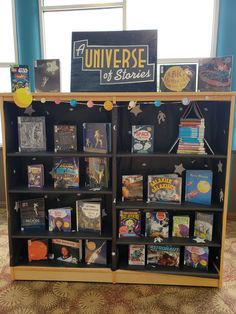 an open bookcase with several books on it in front of a sign that says university of stories