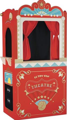 an old fashioned red theater booth with curtains on the front and back sides, for children to play in