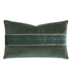 a green pillow with white and black lines on the front, sitting against a white background