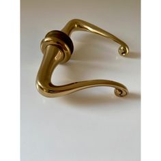 a gold door handle on a white surface