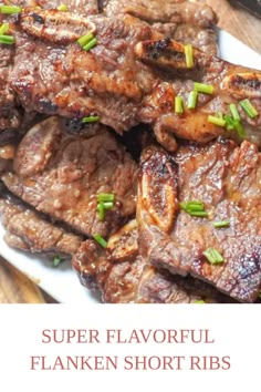 some meat on a white plate with green onions