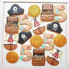 decorated cookies in the shape of pirate's chest and chest of gold are displayed