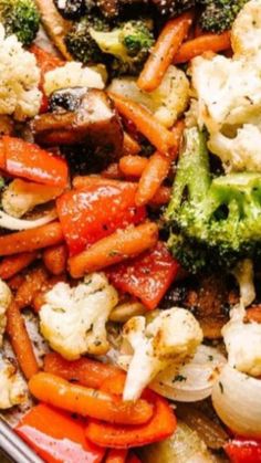 a tray full of vegetables including carrots, cauliflower and broccoli