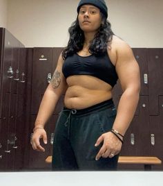 a woman standing in front of lockers with her hands on her hips